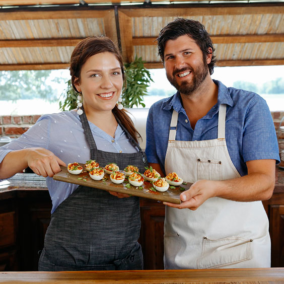 Cody Carroll and Samantha Carroll holding up food they have prepared