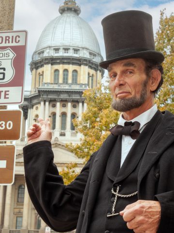 Abe Lincoln actor in front of Route 66 sign in Springfield Illinois