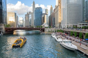 boats on the chicago river in chicago il with skyscrapers in the background