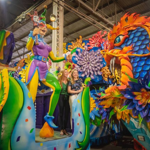 two women standing on a mardi gras float at mardi gras world in new orleans